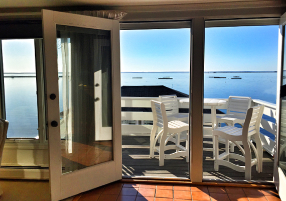 Waterfront 3+ Bed, 2 Bath Apartment. Includes waterfront balcony with seating for 4, fully stocked kitchen, full dining room seating for 8, full living room with harbor and beach views, media room with fireplace, air conditioning and heating, WiFi, iHome, Comcast TV/DVD.